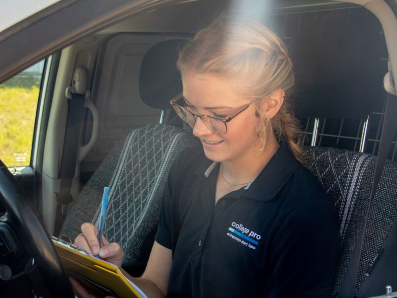 A College Pro team member reviewing a quote and lighting layout on screen